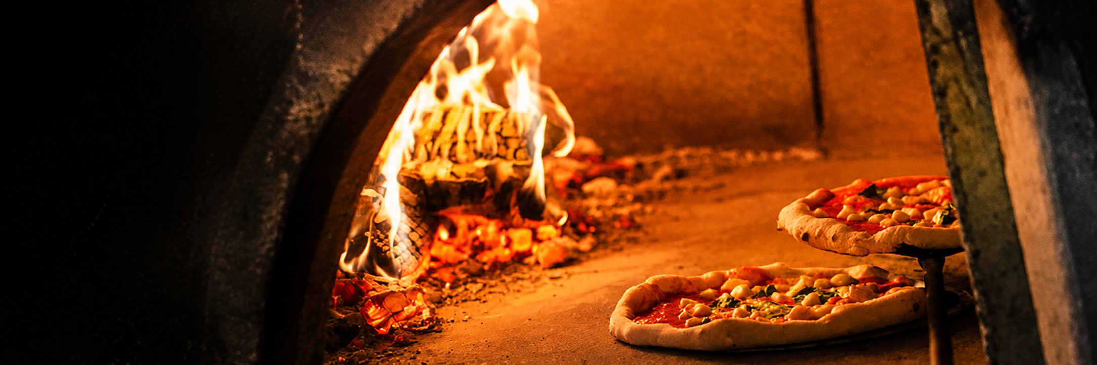 Wood-fired pizzas cooking in an outback oven in Coober Pedy